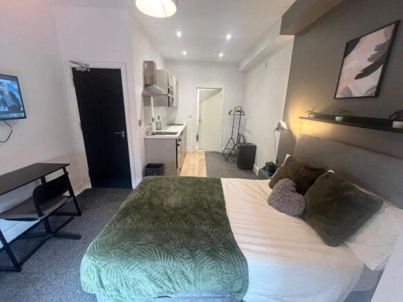 A stylish and well-maintained master bedroom fe...