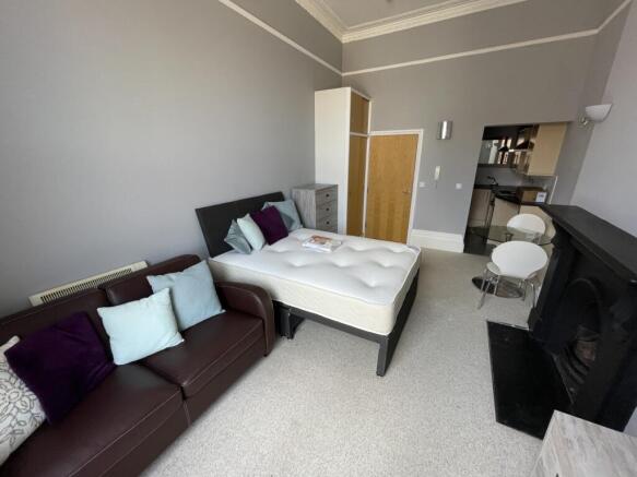 A well-appointed master bedroom featuring a com...