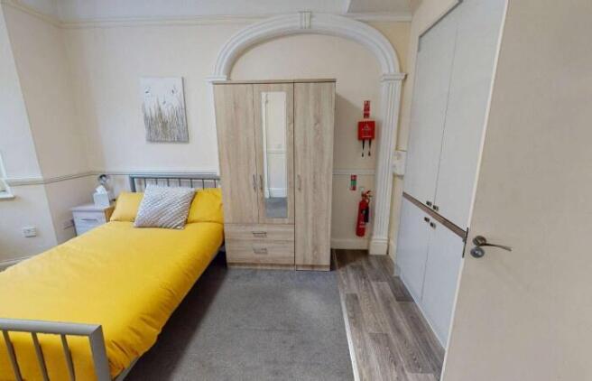 A bright and tidy double bedroom featuring a co...