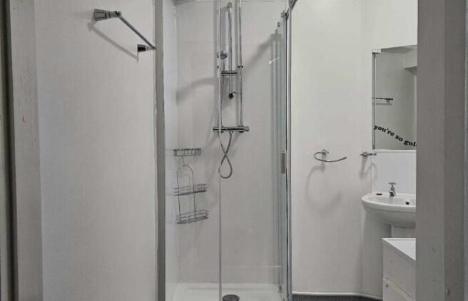 A clean and modern bathroom suite featuring a g...
