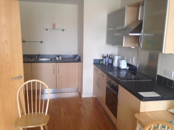 Well-maintained kitchen with modern wooden cabi...
