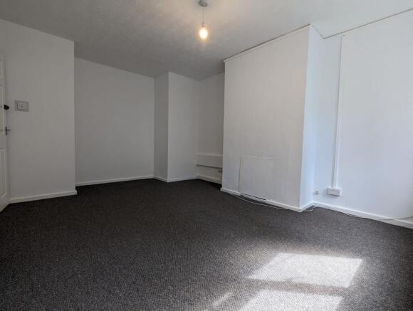 A clean, empty room with fresh white walls and ...