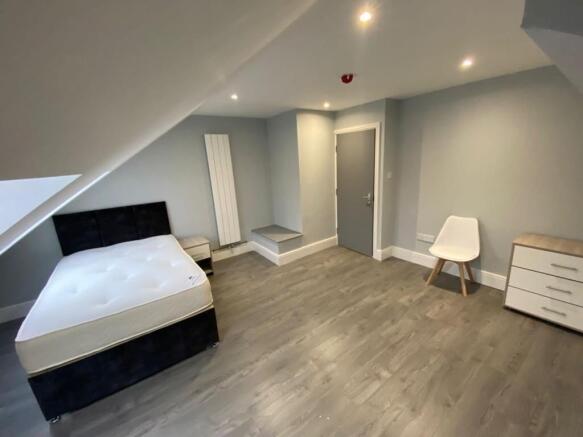 This stylish double bedroom features ample natu...