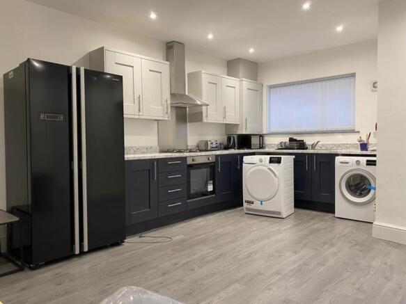 Modern kitchen featuring sleek cabinetry, a spa...