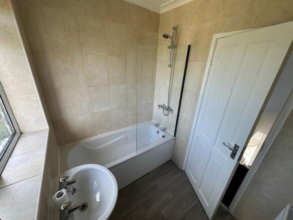 Bright and modern bathroom featuring a clean wh...