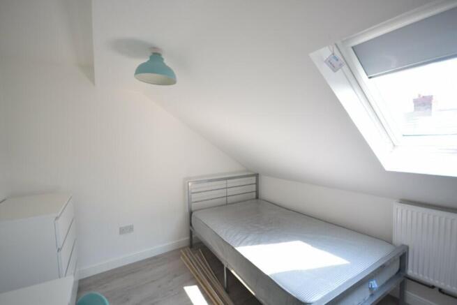 A bright and airy double bedroom with a spaciou...