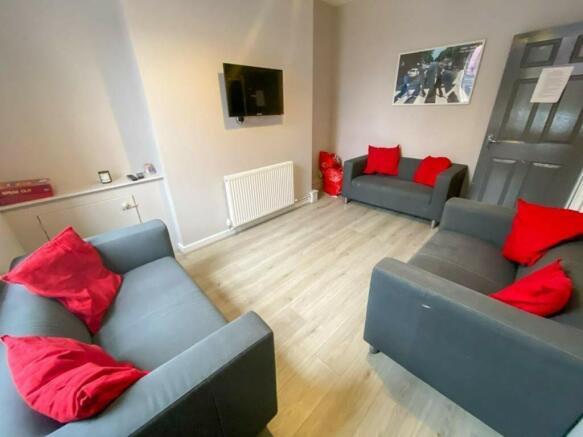 A spacious and inviting modern living room, per...