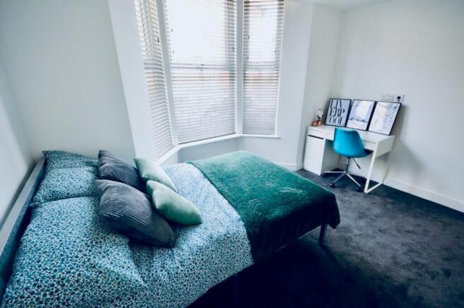 This charming double bedroom features a comfort...