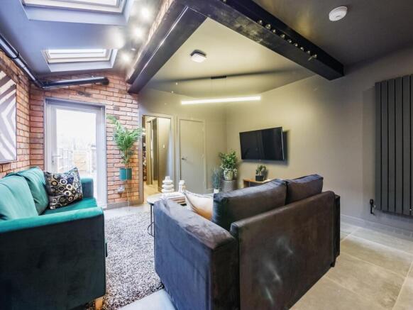 A stylish contemporary living room with exposed...
