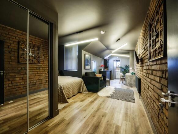 A stylish, spacious master bedroom featuring ex...