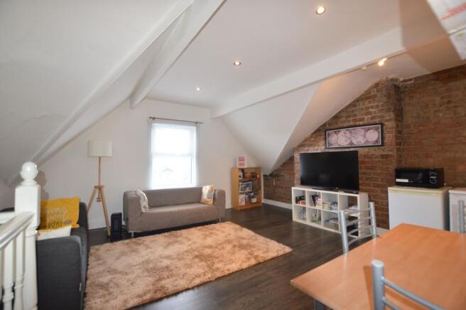 A cozy and well-maintained living room featurin...