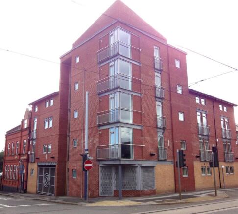 A modern red brick corner townhouse with large ...