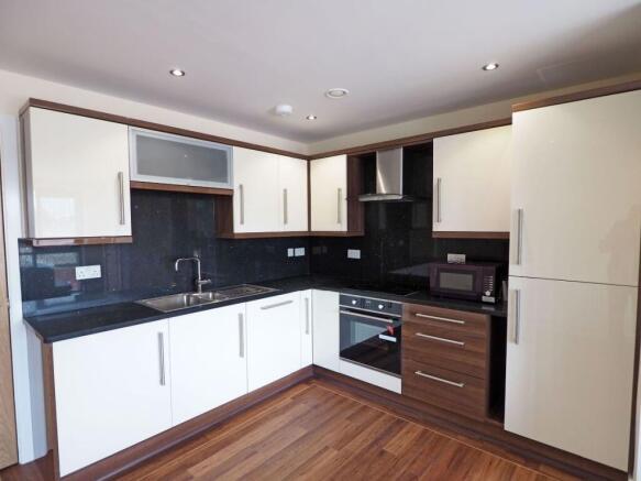 Modern and clean kitchen featuring sleek cream ...