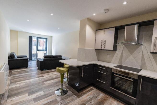 A modern open-plan living room and kitchen area...