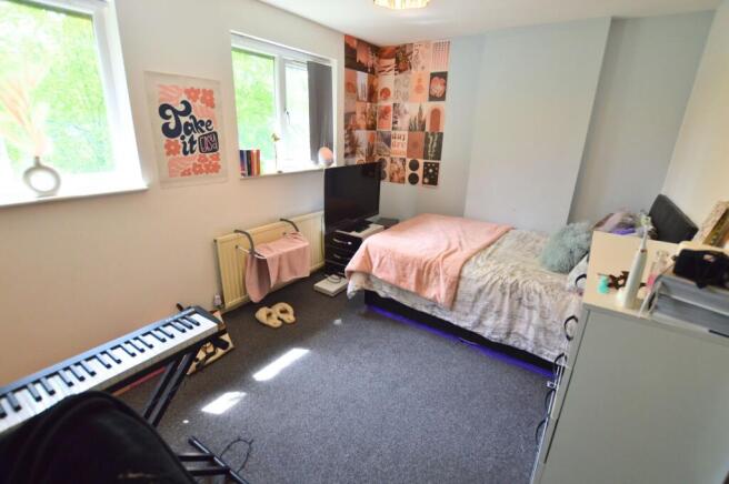 Bright and cozy single bedroom featuring a comf...