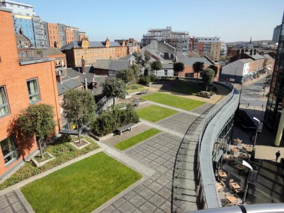 A well-maintained garden area surrounded by mod...