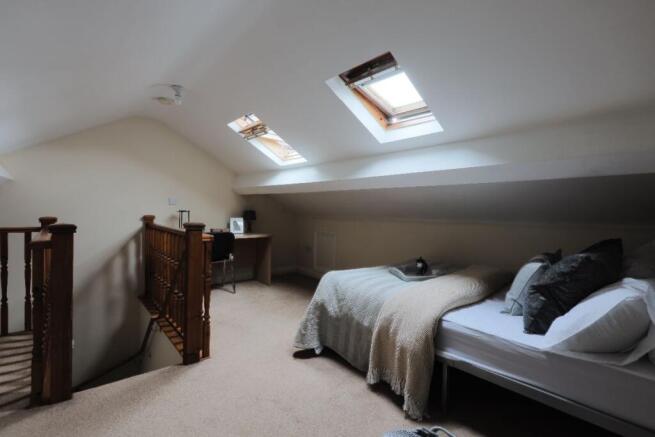 Spacious master bedroom featuring a comfortable...