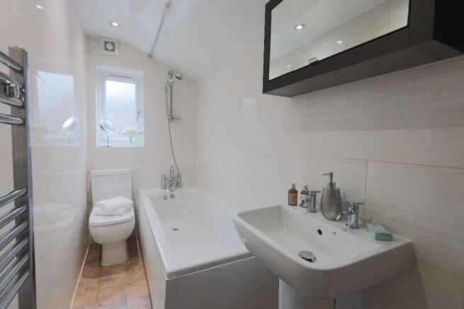 Bright and modern bathroom suite featuring a ba...