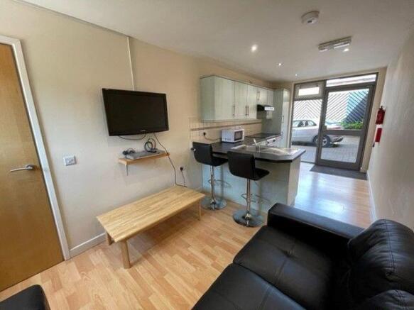 A modern living room featuring a sleek black so...