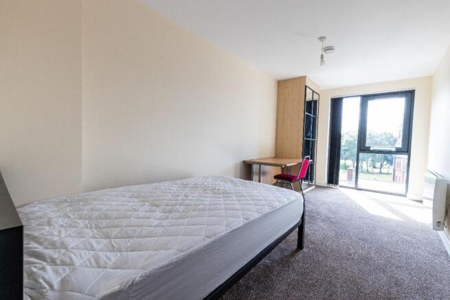 Bright and spacious master bedroom featuring a ...
