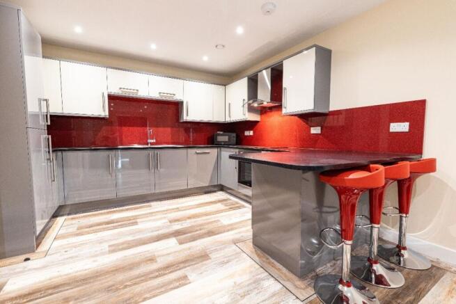 Modern kitchen with glossy cabinets, vibrant re...