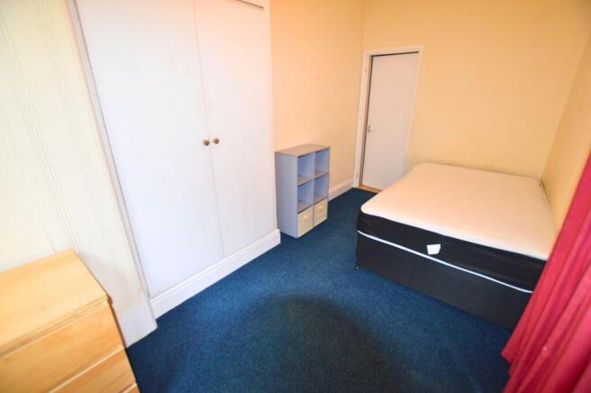 Bright double bedroom featuring a comfortable b...
