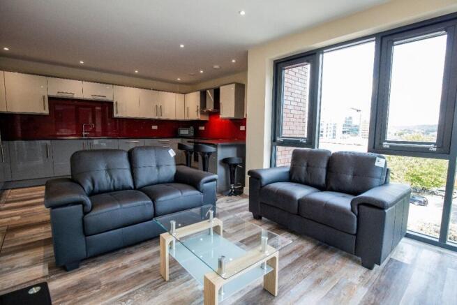 Bright and modern living room featuring large w...