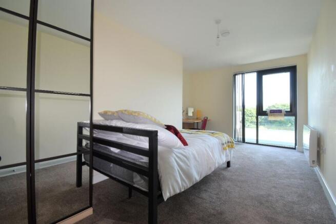 Bright and tidy double bedroom featuring a comf...