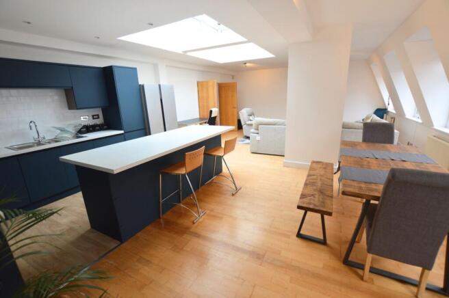 Spacious and modern open-plan living area featu...