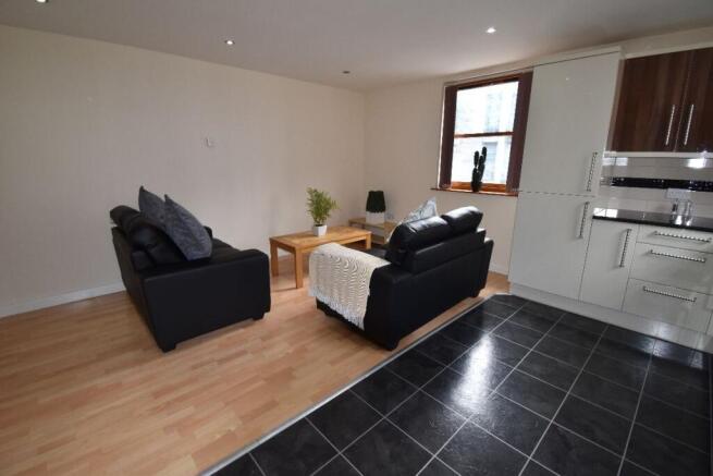 A modern living room with comfortable black sof...