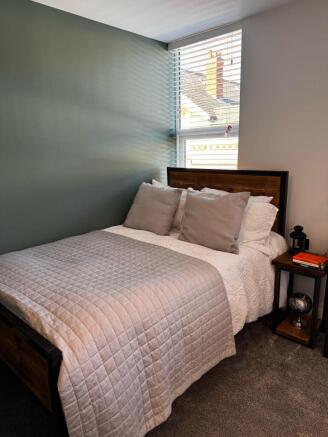 A bright and cozy double bedroom featuring a wo...