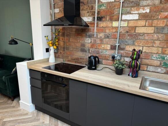 Modern kitchen featuring a sleek electric hob a...