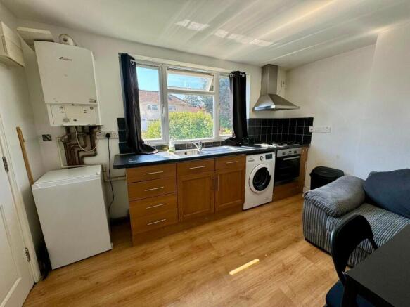 Bright kitchen with a large window offering nat...