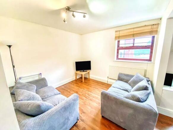 Bright and inviting living room featuring two c...