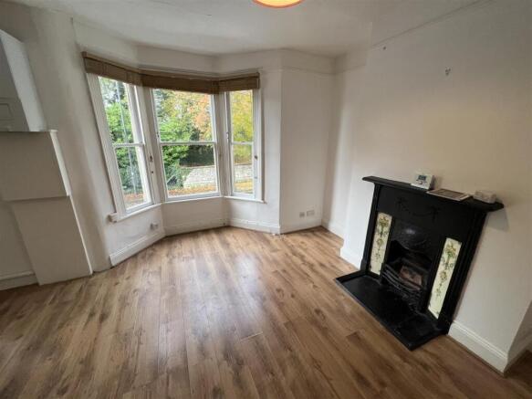 Bright living room featuring large bay windows ...