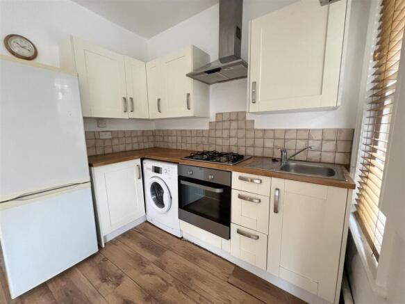 Bright and tidy kitchen featuring modern applia...