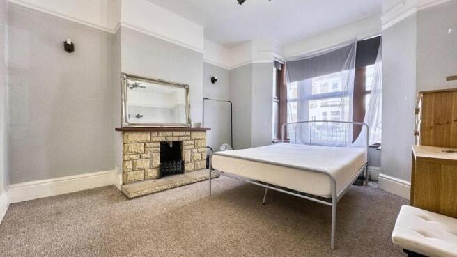 A spacious and bright master bedroom featuring ...