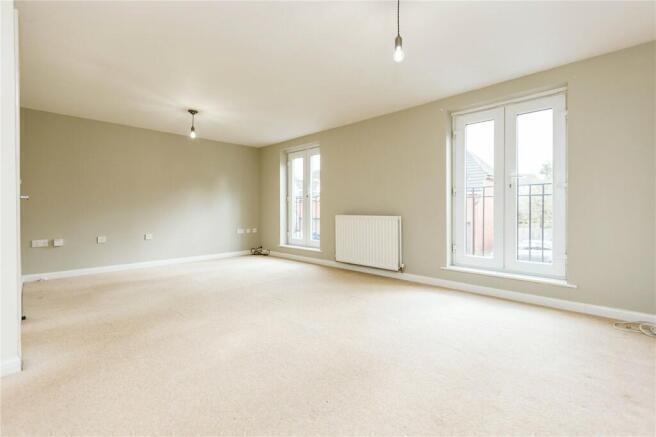 A bright and spacious living room featuring lar...