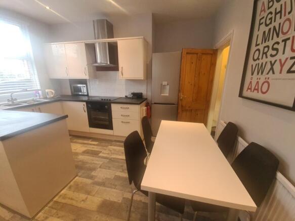 A bright and modern kitchen featuring ample nat...