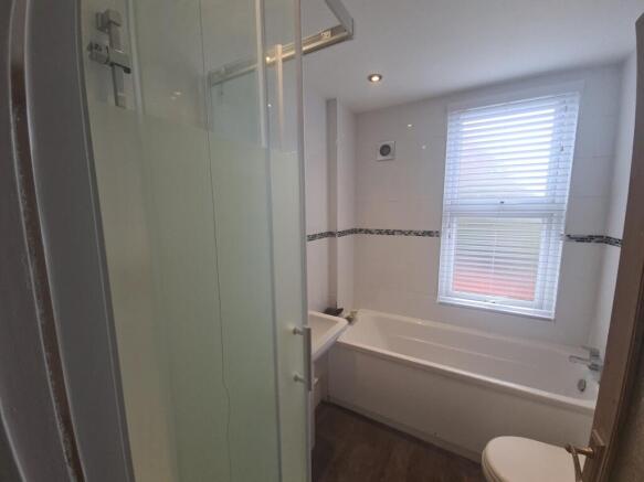 A bright and modern bathroom suite featuring a ...