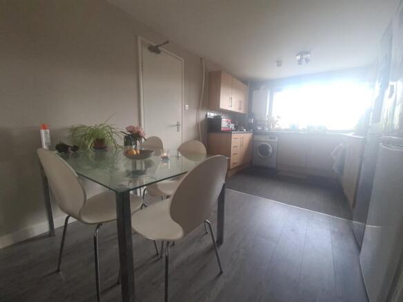 A bright and tidy kitchen featuring a glass din...