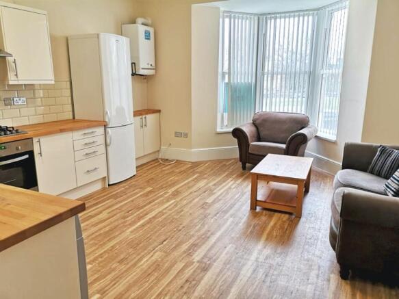 Spacious and bright living room featuring large...