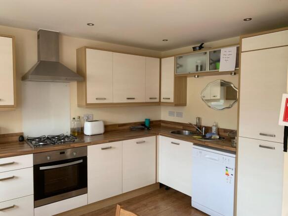 Bright and modern kitchen featuring clean woode...