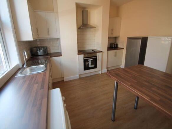 Bright and tidy kitchen featuring modern applia...
