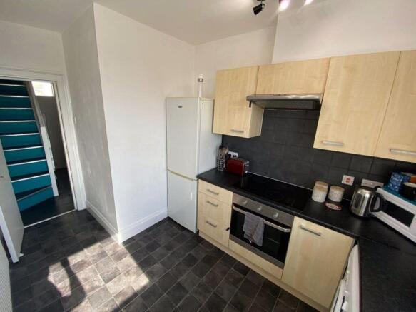 Bright and modern kitchen featuring light wood ...