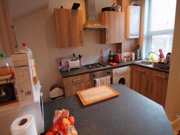 A cozy, well-equipped kitchen featuring wooden ...