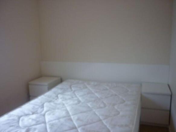 A simple double bedroom featuring a clean mattr...