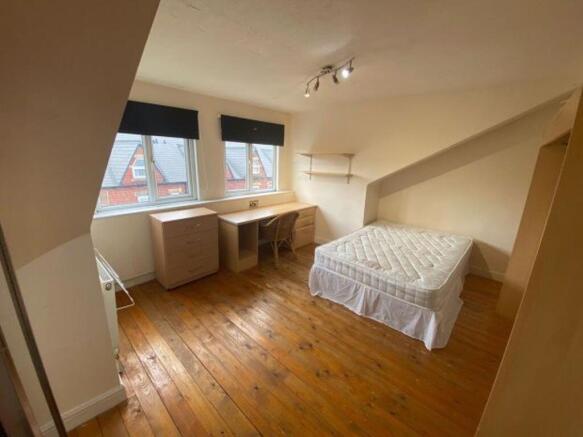 Bright and spacious master bedroom featuring na...