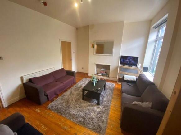 Spacious and inviting living room featuring com...
