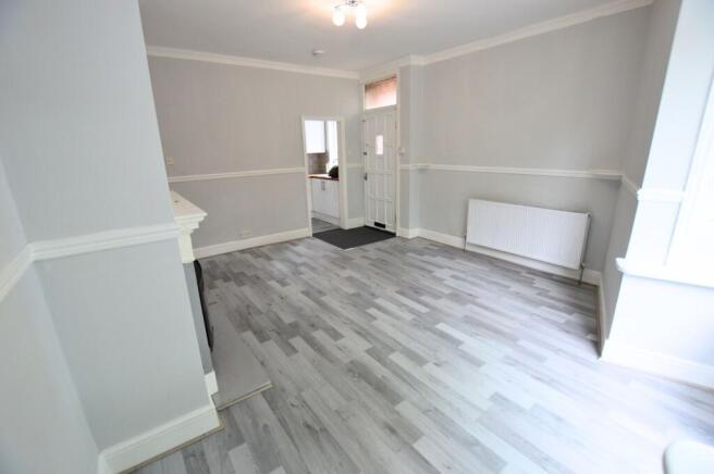 Bright and freshly decorated living room featur...